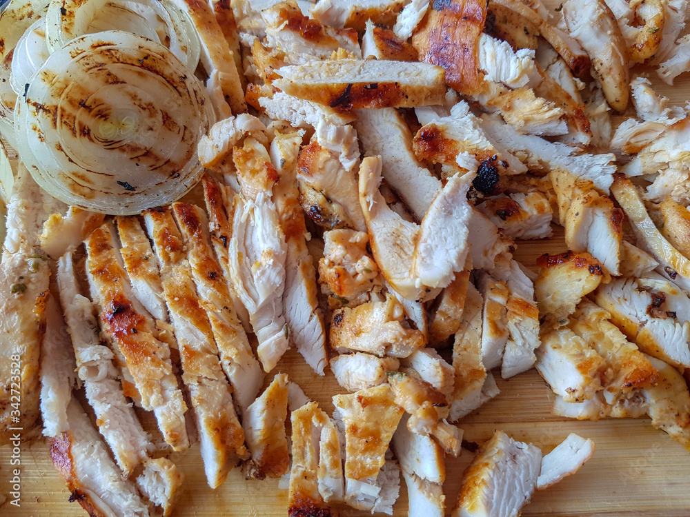 Grilled chicken finely chopped and whole sliced onion grilled on a wooden board. Home made to be put into a doner kebab. Grilled chicken finely chopped and whole sliced onion grilled on a wooden board. Home made to be put into a doner kebab.