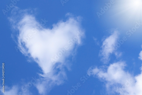 White cloud in the shape of a heart in the blue sky. Natural shape heart in the sky with clouds. Heart shaped cloud over blue sky. 