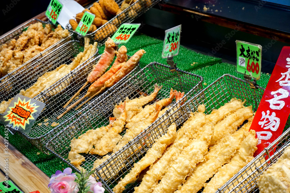 Osaka, Japan, January 14 2019 : Closeup variety Japanese fried seafood snack sell in Kuromon ichiba market. It is a snack food that Chinese people like to buy and eat when visiting this market.