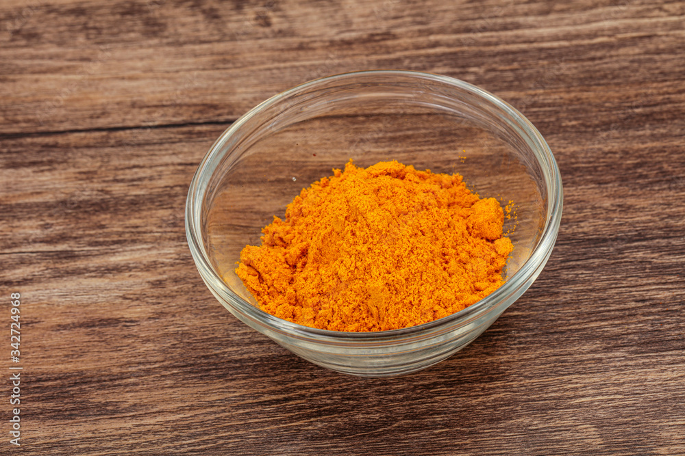 Tumeric powder in the bowl Tumeric powder in the bowl
