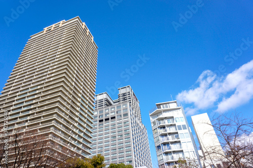 Osaka, Japan-January 18, 2019 : Landscape of city building on bright blue sky with clouds background.