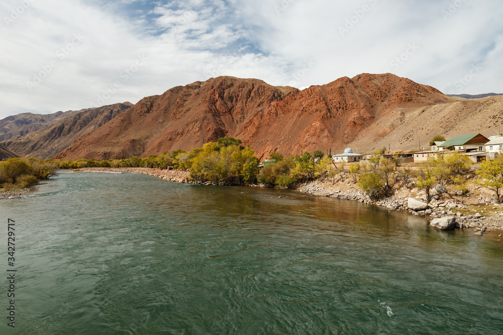 Kokemeren river, houses by the river in the village of Aral, Jumgal district of Naryn region in Kyrgyzstan.