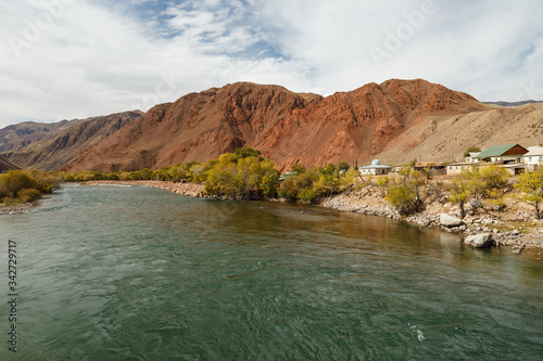 Kokemeren river, houses by the river in the village of Aral, Jumgal district of Naryn region in Kyrgyzstan.
