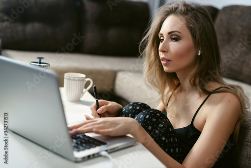 Young woman working successfully at home using laptop. Coronavirus. Quarantine. isolation, social distancing, freelance work from home office, self-isolation.