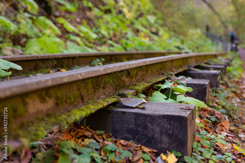 A old narrow gauge railway. A canyon Guamka, Russia, Krasnodar. A forest, a creek and rock at autumn.