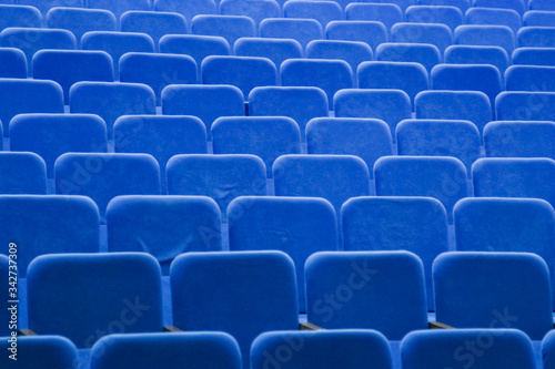 Blue empty seats in the hall are prepared for participants of mass events. Organization and holding of mass events, conferences or presentations