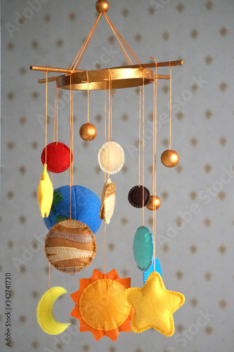 baby mobile over the bed in the form of space bodies