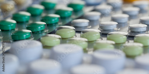 blisters with white, yellow and green tablets