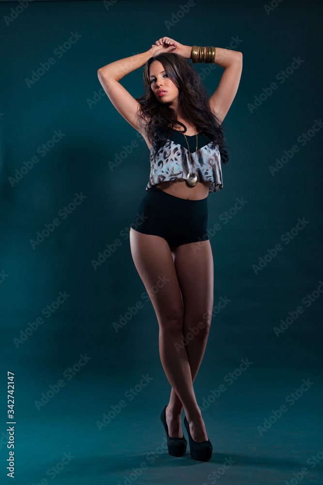 Portrait of a beautiful dancing woman on dark background with lights