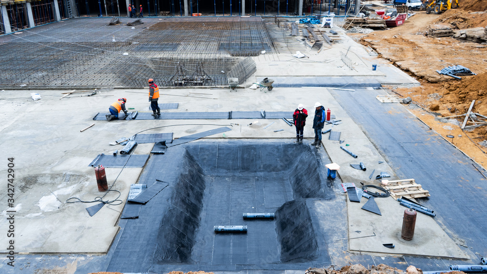 Construction, fittings, excavator, workers in suits, fastening fittings