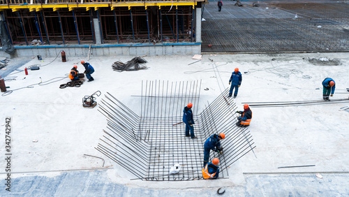 Construction, fittings, excavator, workers in suits, fastening fittings, hydraulic press couplings.