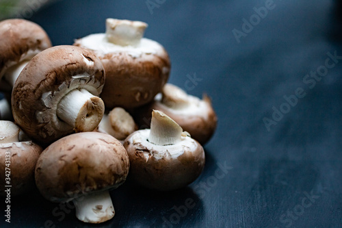 A heap of fresh mushrooms on a blue background