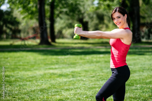 Young athletic fitness woman working out at the park. Lifestyle