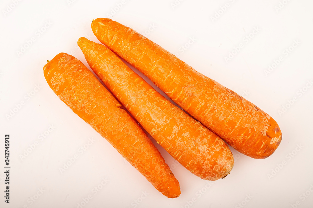 a few ripe carrots on a white background. Close up. a few ripe carrots on a white background. Close up.