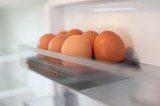Close-up of group of chicken eggs in the fridge container. Domestic food breakfast
