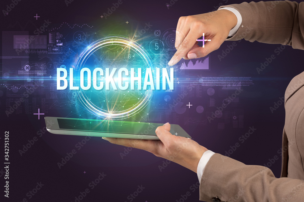 Close-up of a touchscreen with BLOCKCHAIN inscription, new technology concept Close-up of a touchscreen with BLOCKCHAIN inscription, new technology concept