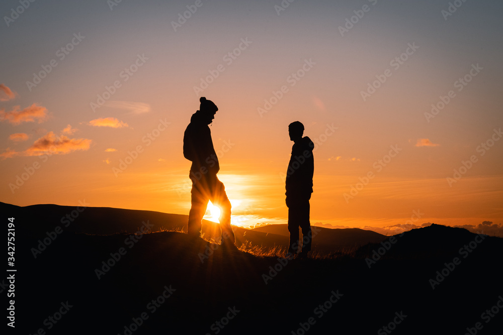 Walker's silhouettes at sunset in the Lake District