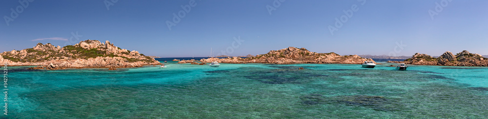 Panoramic view of the pink granite rock formations and the clear and transparent waters in the Maddalena archipelago in Sardinia, Italy.