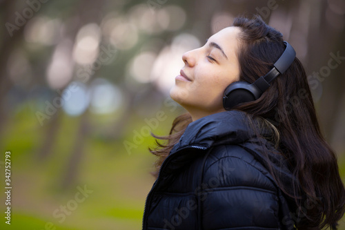 Beauty girl listen to the music in park