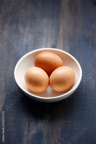 Brown eggs with wooden background