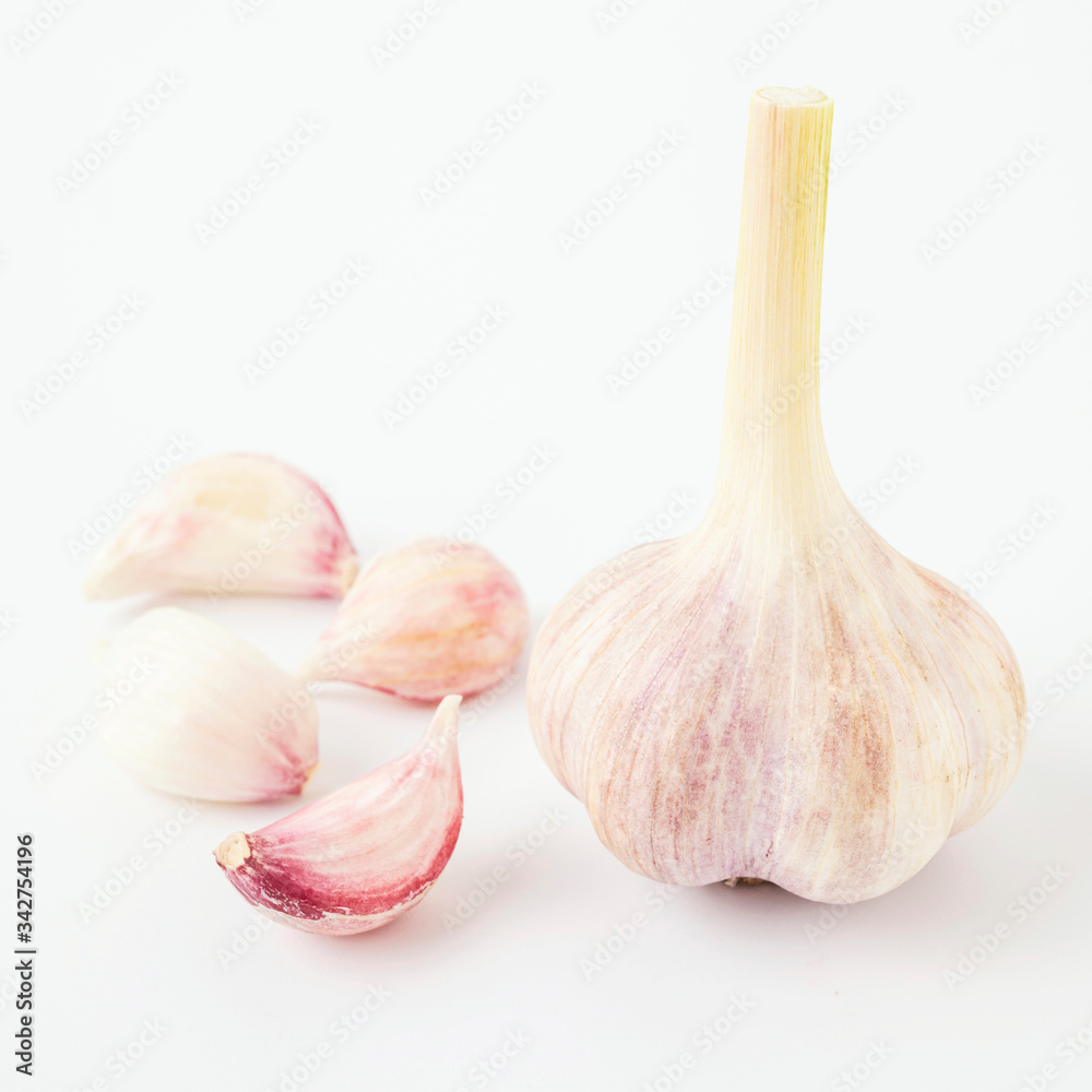 Obraz premium light fresh garlic with cloves lying side by side on a white background isolate