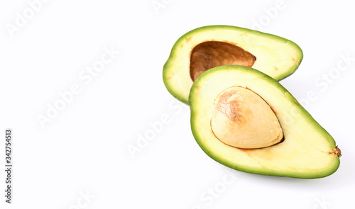 green avocado halves with a bone on a white background isolate