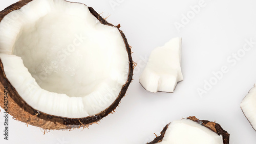 ripe coconut in a shell with open flesh and pieces on a white background isolate