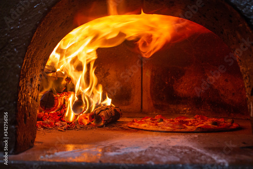 cooking pizza in a traditional fire oven