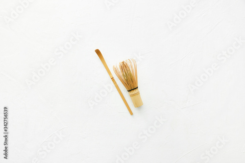 Bamboo whisk and chashaku bamboo spoon for green tea matcha isolated on white. photo