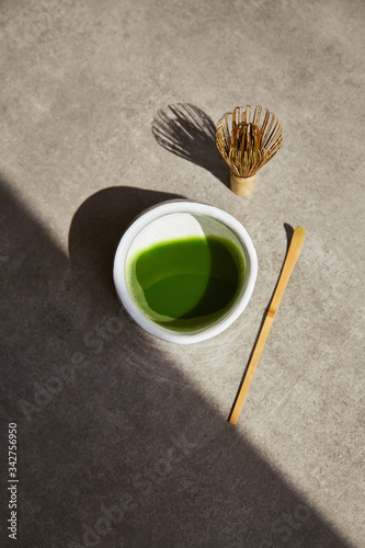 Tea matcha composition with shadow on a gray background.