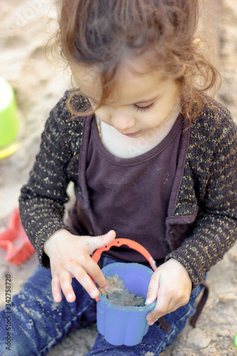 Little kid girl playing wit...