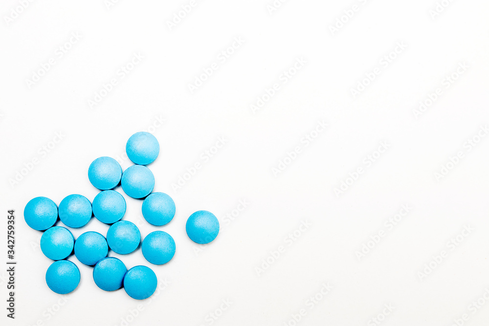 Blue pills on a white background. Space for text. Concept for medical news.