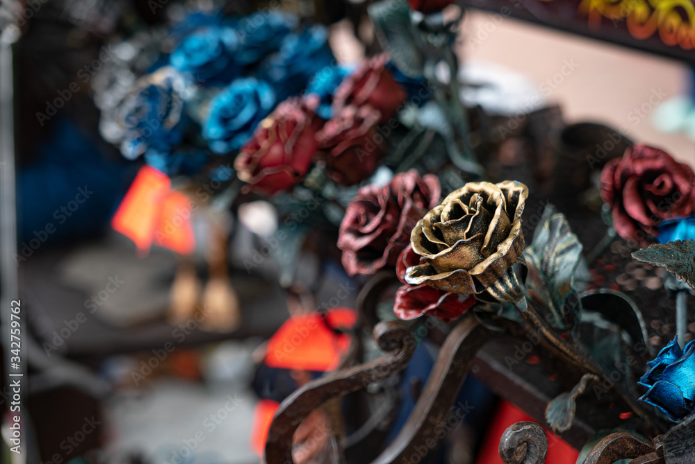 Colored metal roses on the street market.