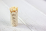Bamboo toothstick in a case over the white table.