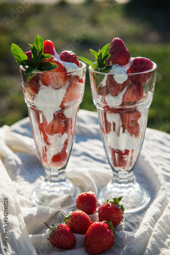 Fresh strawberries with yoghurt and whipped cream. Breakfast time. Healthy food. Delicious dessert sugar free. Vegetarian dish. Spring time 