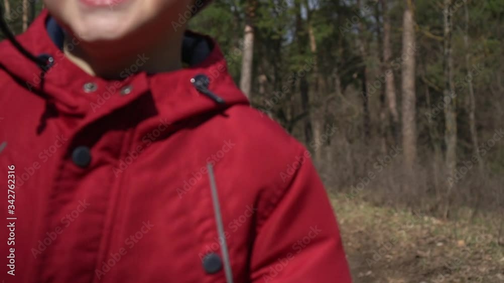 boy runs through the woods on camera.slow mo boy runs through the woods on camera.slow mo