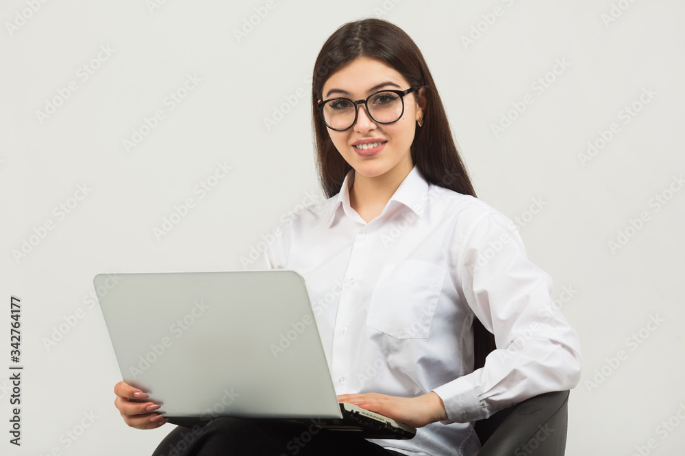 beautiful young woman in glasses on a white background with a laptop beautiful young woman in glasses on a white background with a laptop