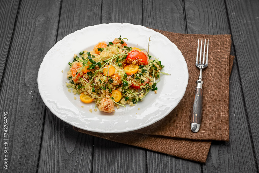 salad with bulgur and vegetables, Tabbouleh, on a dark wood background. tinting. salad with bulgur and vegetables, Tabbouleh, on a dark wood background. tinting.