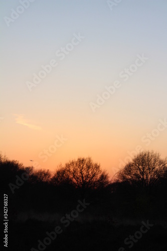 Beautiful and vibrant sunset, with the colours changing from a pink/orange colour into a clear blue sky