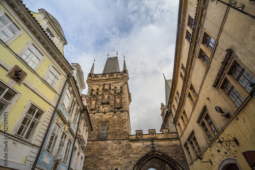 Picture of the lesser town bridge tower of Charles Bridge, also called malostranska mostecka vez in Prague, Czech Republic, surrounded by narrow medieval streets and houses photo