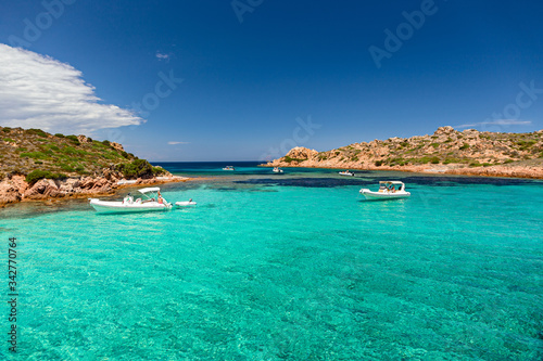 Fototapeta Naklejka Na Ścianę i Meble -  Panoramic view of the pink granite rock formations and the clear and transparent waters in the Maddalena archipelago in Sardinia, Italy.