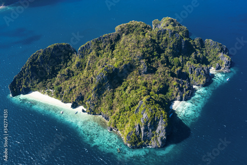 View from above, aerial view the Entalula Island with a beautiful white sand beach bathed by a turquoise, crystal clear sea. Bacuit Bay, El Nido, Palawan, Philippines..