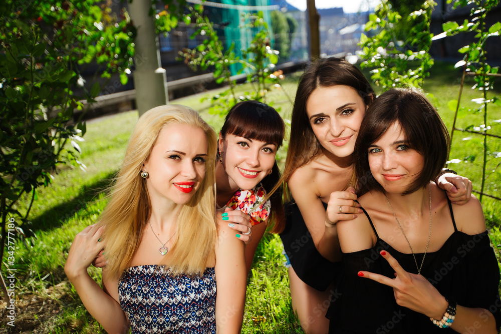 beautiful four women in the park, happy smiling