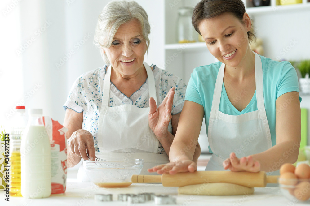 Beautiful women baking in the kitchen at home
