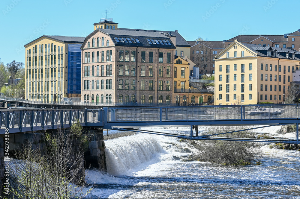 Motala river and the historic industrial landscape during spring in Norrkoping. Norrkoping is a historic industrial town in Sweden.
