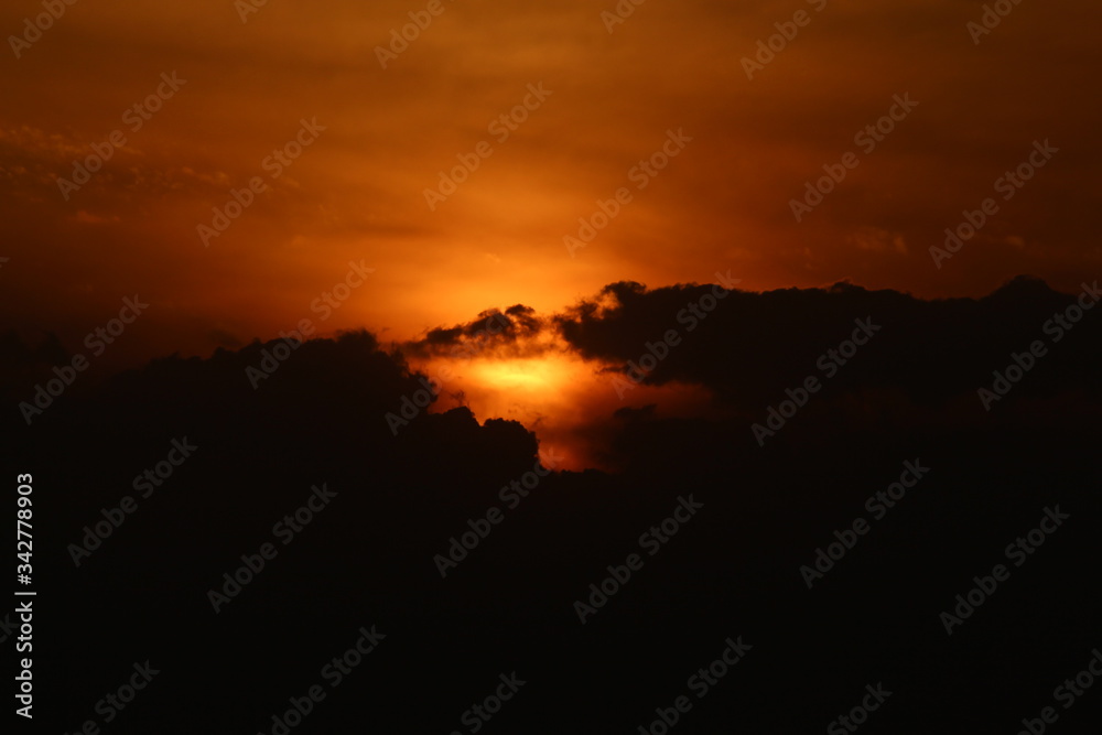 A sunset View of the sun under black sky. A sunset View of the sun under black sky.