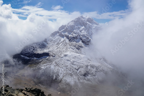 ILINIZA VOLCANO  ECUADOR - DECEMBER 04  2019  View from the north peak towards the snow covered south peak emerging from the mist 