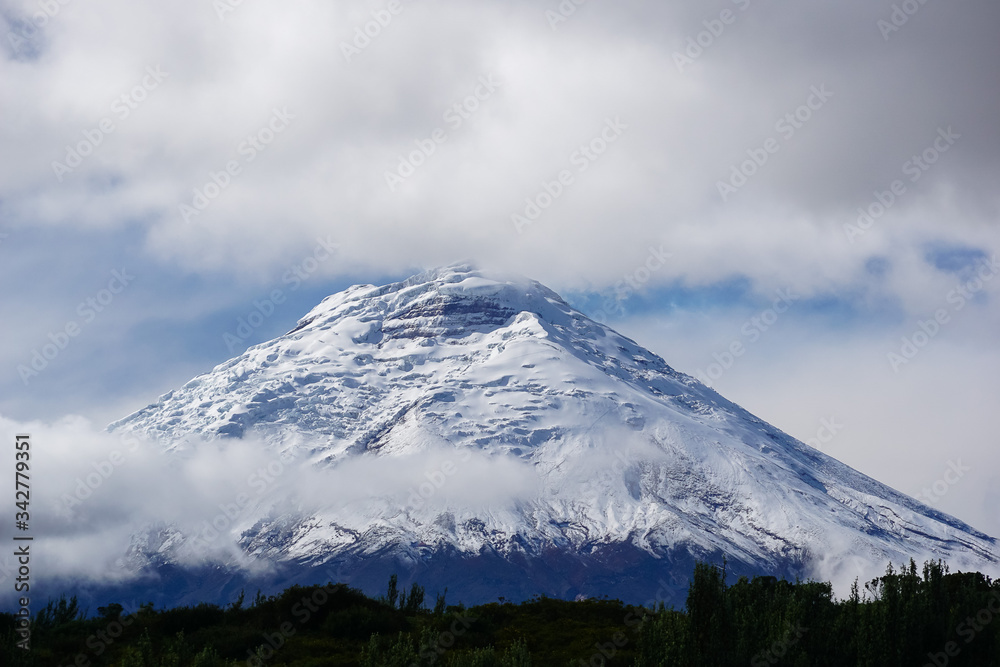 COTOPAXI VOLCANO, ECUADOR - DECEMBER 05, 2019: View towards the snow covered volcanic cone above the clouds