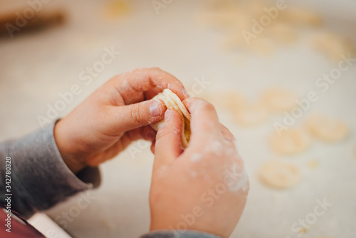 Wallpaper Mural Close-up of boy's hands sculpting dumplings at home. Cooking home Torontodigital.ca