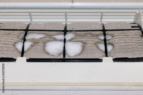 Iced and dusted air conditioner's filter before cleaning by mechanic